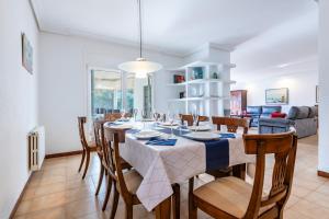 a dining room and living room with a table and chairs at Mario in Vinaròs