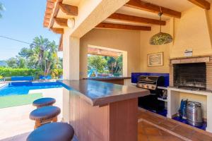 a kitchen with a counter and a swimming pool at Casa Emilia in Moraira