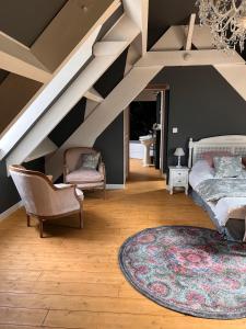 a attic room with a bed and a rug at Domaine Du Turbais in Luynes