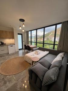 a living room with a couch and a table at Mirşah SUİT in Bezkesen