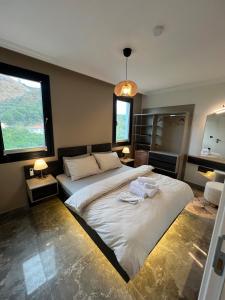 a bedroom with a large bed and a large window at Mirşah SUİT in Bezkesen