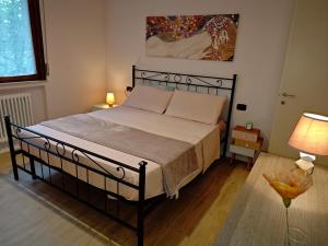 a bedroom with a large bed with a black frame at B&b La Lucciola in Salsomaggiore Terme