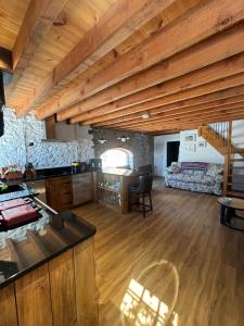 a kitchen and living room with a wooden ceiling at Kells Yard in Feevaghmore