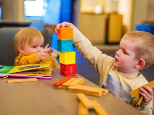 two children sitting at a table playing with blocks at Novotel Saint Avold in Saint-Avold