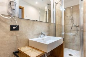 a bathroom with a sink and a shower at Appartamento Cima Brenta in San Lorenzo in Banale
