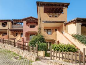 a building with a fence in front of it at Residence Orizzonti 33 in Golfo Aranci
