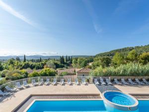 a villa with a swimming pool and lounge chairs at Vacancéole – Le Domaine de Camiole in Callian