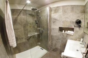 a bathroom with a shower and a sink at Les Flots Bleus in Porto Ota +38 photos