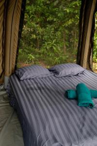 a bed in the back of a tent with two pillows at Bubble Paradise, Koh ta Kiev in Koh Ta kiev Island