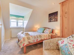 a bedroom with a bed and a couch at 3 Bed in Watchet 37336 in Watchet