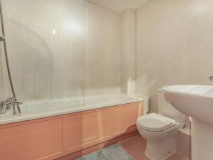 a bathroom with a tub and a toilet and a sink at 3 Bed in Watchet 37336 in Watchet +16 photos