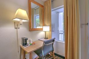 a room with a desk with a lamp and a chair at Hotel Carolina - Double Room 2 Full Beds in Hilton Head Island +9 photos
