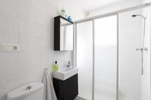 a white bathroom with a sink and a shower at Fuente Del Baden in Nerja +25 photos