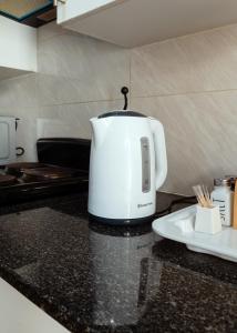 a white toaster sitting on top of a kitchen counter at Cozy and Stylish 2 Bedroom Retreat in Gaborone in Gaborone