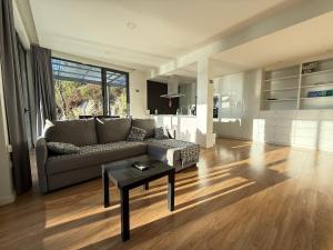 a living room with a couch and a table at Villa Teixugueiras 2 - Gerês in Vieira do Minho
