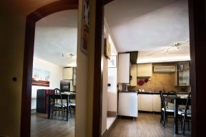a kitchen and dining room with a table and chairs at Attico Sul Mare In Centro in Capo dʼOrlando +12 photos