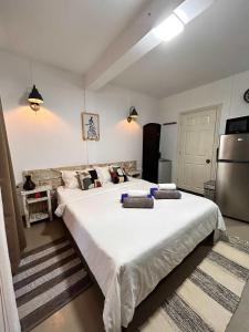 a large bedroom with two beds and a refrigerator at 1-Bedroom Apt 3mins to Beach & Private Restaurant - TRR3 in Pointe aux Cannoniers