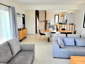 a living room with a couch and a dining room at Maurentvilla in Pointe aux Piments +22 photos