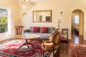 a living room with a couch and a table at Villa Echium T2 in Caniço