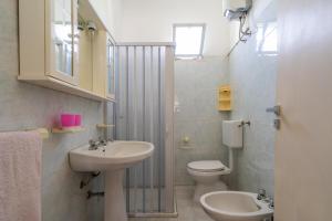 a bathroom with a sink and a toilet at Casa Vacanze Salento in Galatone