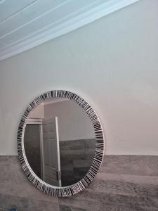 a mirror in a white room with a door at Remmys Place in Hawston +5 photos