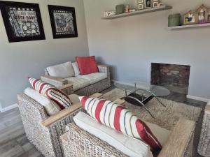 a living room with two couches and a fireplace at Remmys Place in Hawston