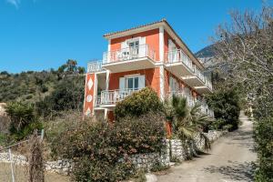 a orange house on the side of a hill at Angela partial sea view 8 in Kefallonia +5 photos