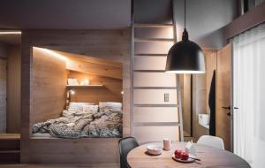 a bedroom with a bed in a wooden wall at Rousa little guesthouse Kombi in Rasun di Sopra