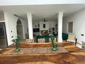 a living room with a table with two trees on it at Riad 4 chambres, Piscine chauffée, Petit déjeuner inclus in Marrakesh