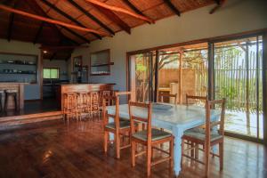 a kitchen and dining room with a table and chairs at Tree House Villa in Praia do Tofo