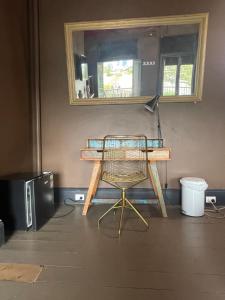 a desk with a chair in a room with a mirror at Glengarry Castle Hotel in Sydney