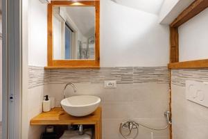 a bathroom with a sink and a mirror at Logge dei Paroloti Paolo in San Lorenzo in Banale +27 photos