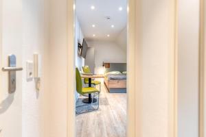 a hallway with a room with a bed and a desk at Schmidt-einander W 8 in Norderney
