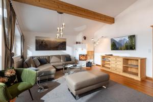 a living room with a couch and a table at Penthouse Appartement in Kirchberg in Tirol