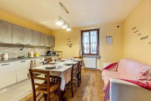 a kitchen with a table and chairs and a kitchen with a tableablish at Cascina Raperonzolo in Lonato del Garda