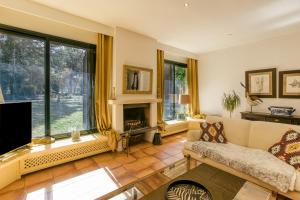 a living room with a couch and a fireplace at Villa Maria in Navata