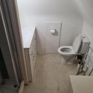 a white bathroom with a toilet and a sink at Cozy spacious room in Sole Street
