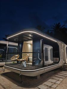 Sunny Pavilion Thoddoo في ثودو: عربة سكنية متنقلة متوقفة مع طاولة وكراسي بداخلها