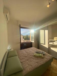 a bedroom with a large bed and a window at Villa Ferrari - Park Monza F1 Circuit in Villasanta