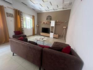 a living room with a couch and a table at Mpita 2 in Pointe-Noire