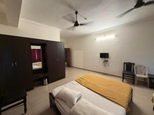 a bedroom with a bed and a ceiling fan at Downtown in Manipala