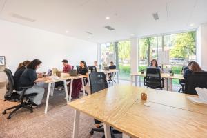 a group of people sitting at tables in a room at BABEL COMMUNITY Hôtel Saint-Quentin-en-Yvelines in Montigny-le-Bretonneux