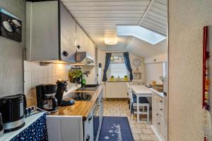 a kitchen with a sink and a counter top at Ferienhaus Grietjes Huus in Krummhörn
