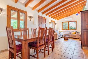 a dining room with a wooden table and chairs at Finca Biniali in Sencelles