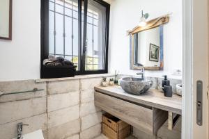 a bathroom with a sink and a mirror at Dimora della Dogana in Pescia Romana +18 photos