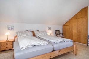 a bedroom with two beds with white sheets at Annemarie und Walter Hechelmann in Lindau