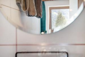 a mirror in a bathroom with a christmas tree at Sonnberg in Stall +14 photos