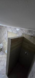 a bathroom with a shower with a door and a toilet at Cooper in Potchefstroom