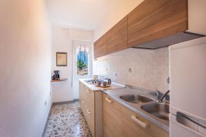 a kitchen with wooden cabinets and a sink at Liver 203 in Tremosine Sul Garda