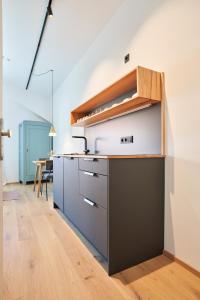 an open kitchen with a counter and a table at Alte Seifensiederei - Cisco in Bad Tölz